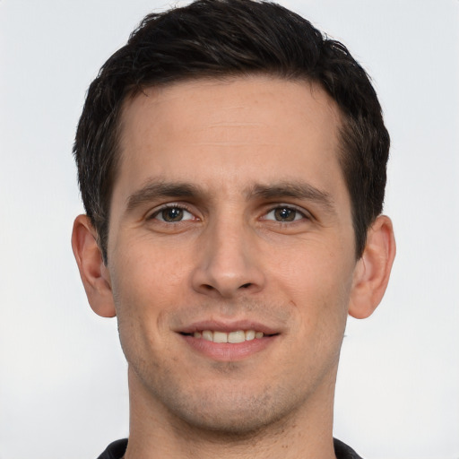 Joyful white young-adult male with short  brown hair and brown eyes