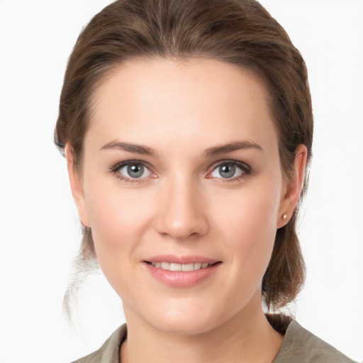 Joyful white young-adult female with medium  brown hair and grey eyes