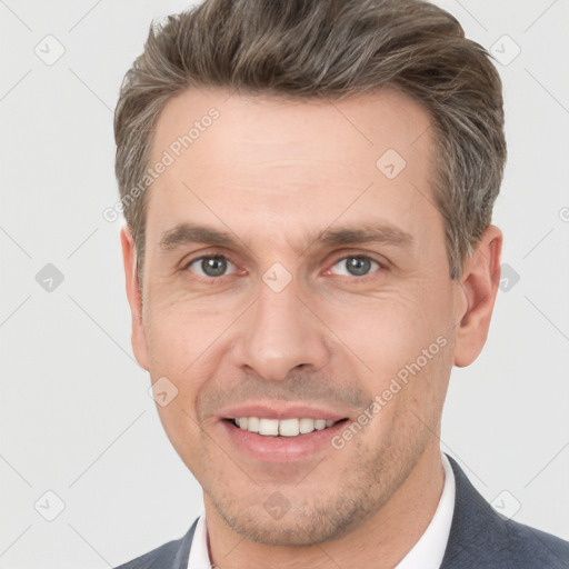 Joyful white adult male with short  brown hair and grey eyes