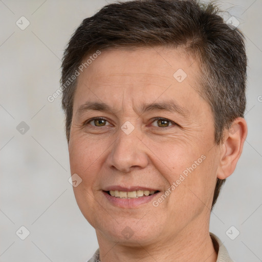 Joyful white adult male with short  brown hair and brown eyes