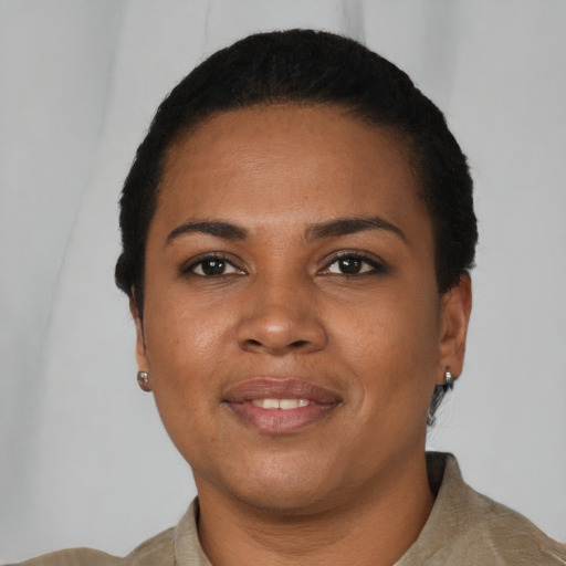 Joyful black young-adult female with short  black hair and brown eyes