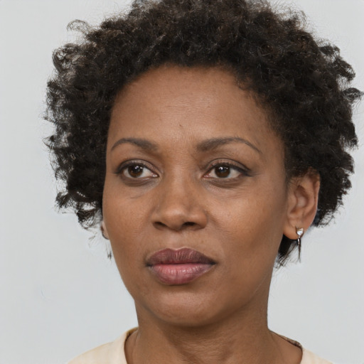 Joyful black adult female with short  brown hair and brown eyes