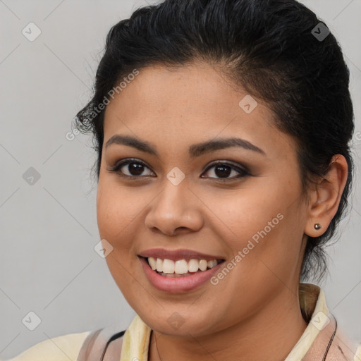 Joyful latino young-adult female with medium  brown hair and brown eyes