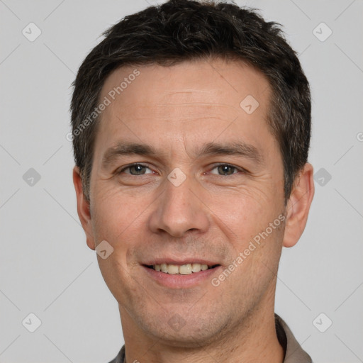 Joyful white adult male with short  brown hair and brown eyes