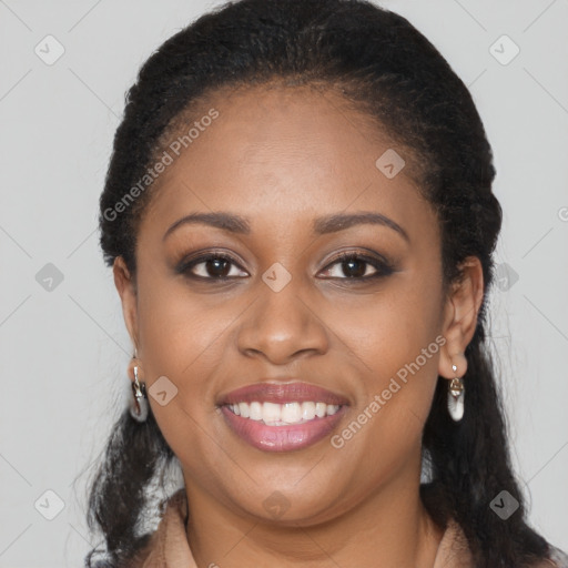 Joyful black young-adult female with long  brown hair and brown eyes