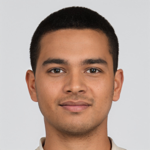 Joyful latino young-adult male with short  brown hair and brown eyes