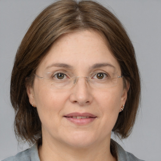 Joyful white adult female with medium  brown hair and grey eyes