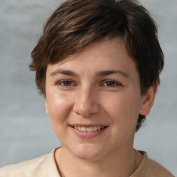 Joyful white young-adult female with short  brown hair and grey eyes