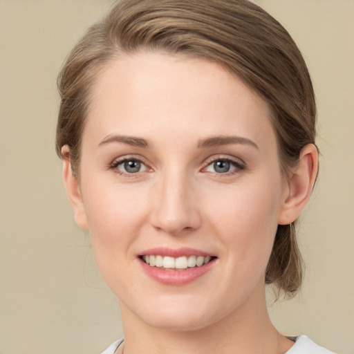 Joyful white young-adult female with medium  brown hair and green eyes