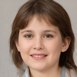 Joyful white child female with medium  brown hair and brown eyes