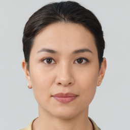 Joyful asian young-adult female with short  brown hair and brown eyes