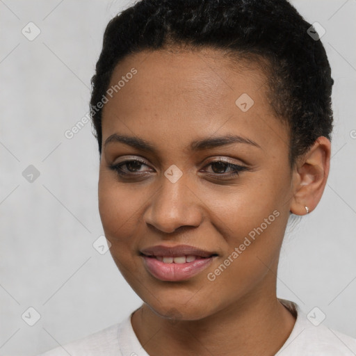 Joyful black young-adult female with short  black hair and brown eyes