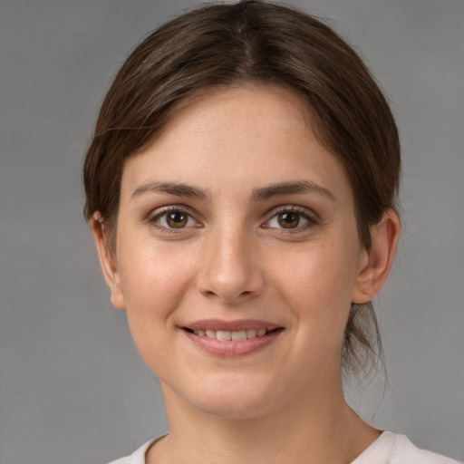 Joyful white young-adult female with medium  brown hair and grey eyes