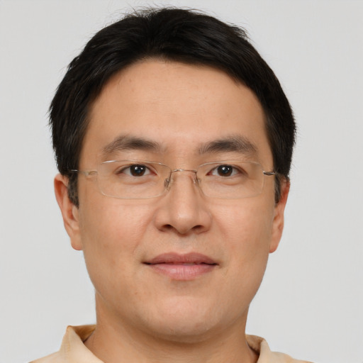 Joyful asian adult male with short  brown hair and brown eyes