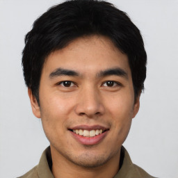 Joyful asian young-adult male with short  black hair and brown eyes