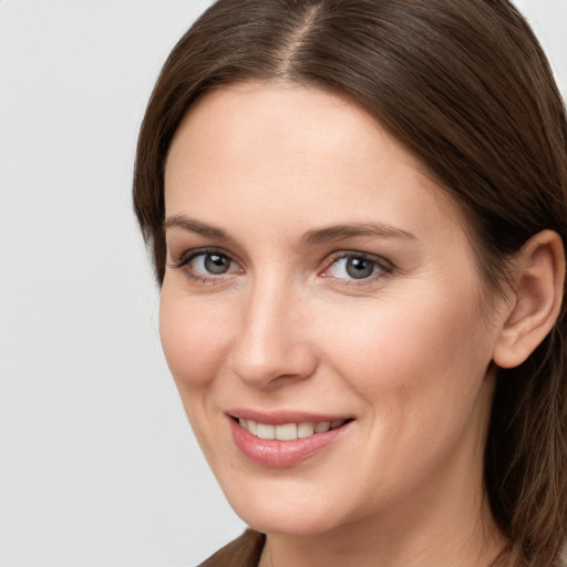 Joyful white young-adult female with long  brown hair and grey eyes