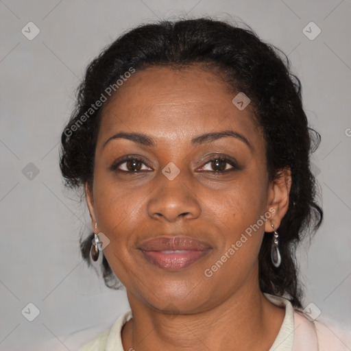 Joyful black adult female with medium  brown hair and brown eyes