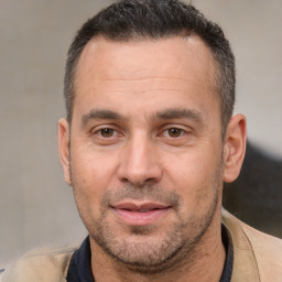 Joyful white adult male with short  brown hair and brown eyes