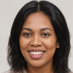 Joyful latino young-adult female with long  brown hair and brown eyes