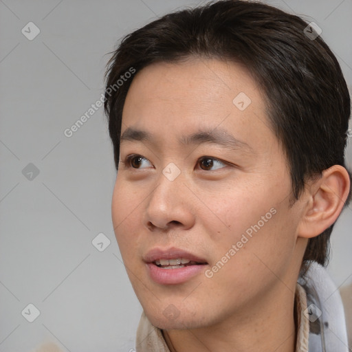 Joyful asian young-adult male with short  brown hair and brown eyes
