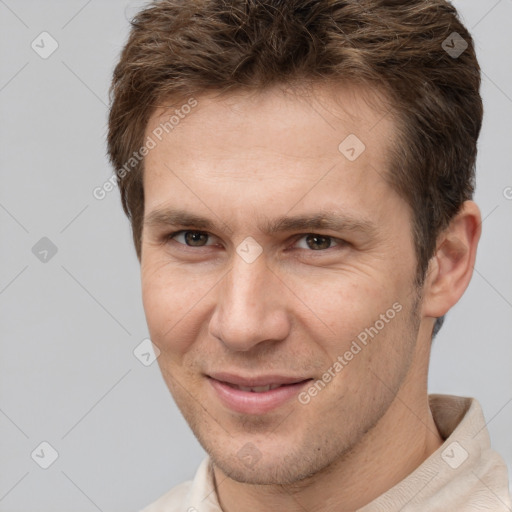 Joyful white adult male with short  brown hair and brown eyes
