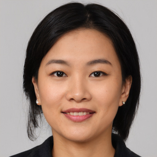Joyful asian young-adult female with medium  black hair and brown eyes