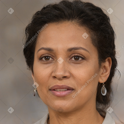 Joyful latino adult female with medium  brown hair and brown eyes