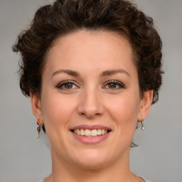 Joyful white young-adult female with medium  brown hair and green eyes