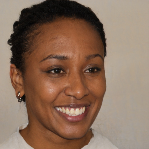 Joyful black adult female with short  brown hair and brown eyes