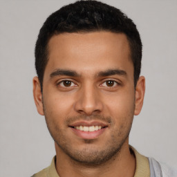 Joyful latino young-adult male with short  brown hair and brown eyes