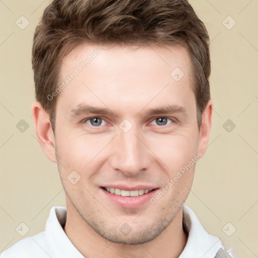 Joyful white young-adult male with short  brown hair and grey eyes