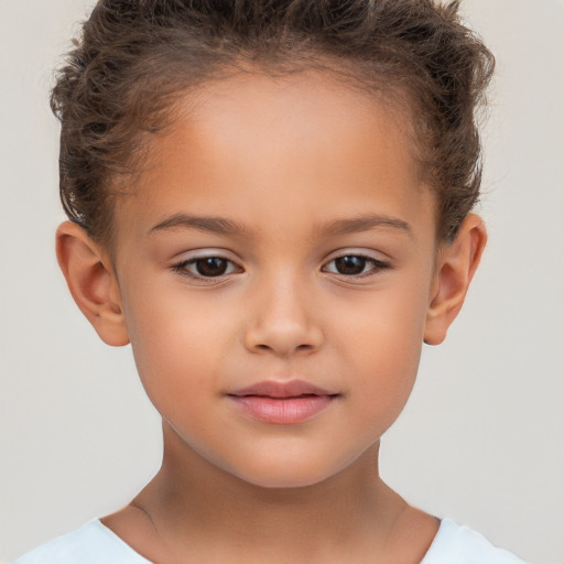 Joyful white child female with short  brown hair and brown eyes