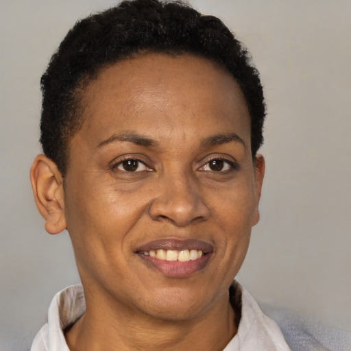 Joyful black adult female with short  brown hair and brown eyes