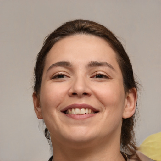 Joyful white adult female with medium  brown hair and brown eyes