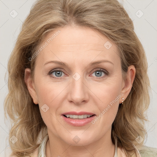 Joyful white adult female with medium  brown hair and blue eyes