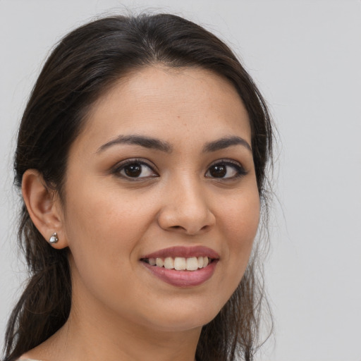 Joyful white young-adult female with long  brown hair and brown eyes