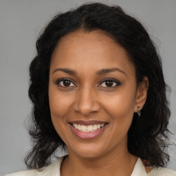 Joyful black young-adult female with medium  brown hair and brown eyes