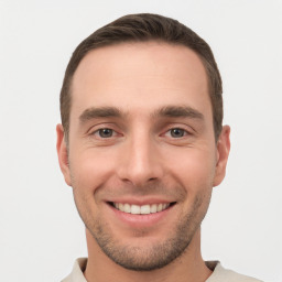 Joyful white young-adult male with short  brown hair and brown eyes