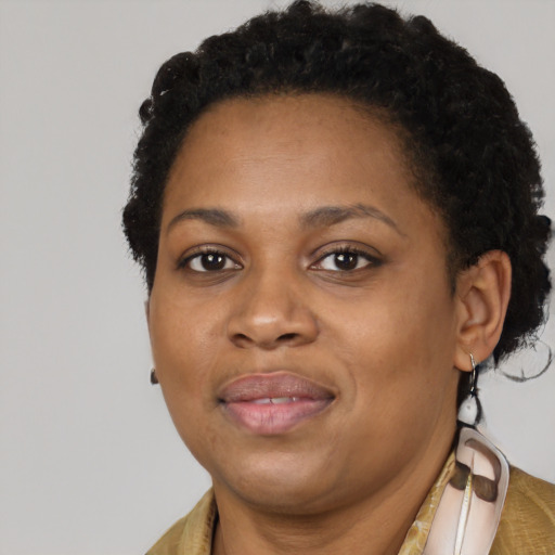 Joyful black adult female with short  brown hair and brown eyes
