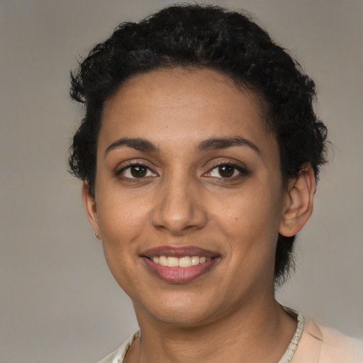 Joyful latino young-adult female with short  black hair and brown eyes