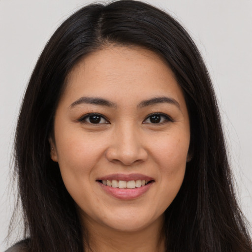 Joyful white young-adult female with long  brown hair and brown eyes