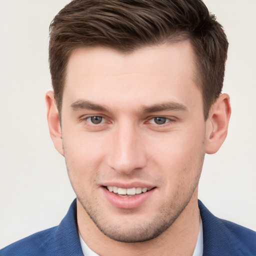 Joyful white young-adult male with short  brown hair and grey eyes