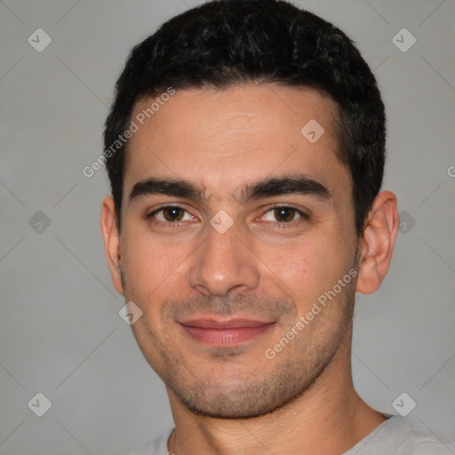 Joyful white young-adult male with short  black hair and brown eyes