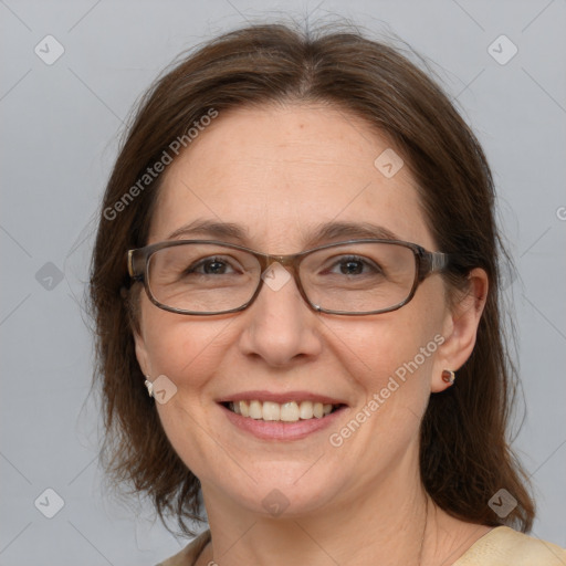 Joyful white adult female with medium  brown hair and grey eyes