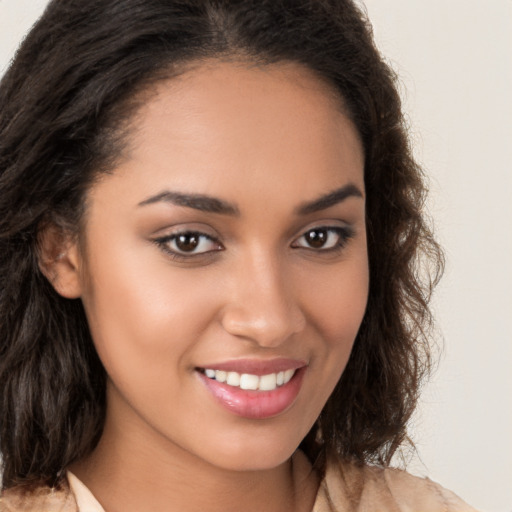 Joyful latino young-adult female with long  brown hair and brown eyes