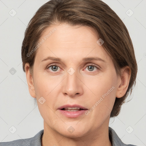 Joyful white adult female with short  brown hair and grey eyes