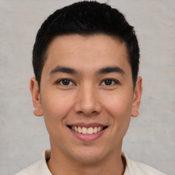 Joyful latino young-adult male with short  brown hair and brown eyes