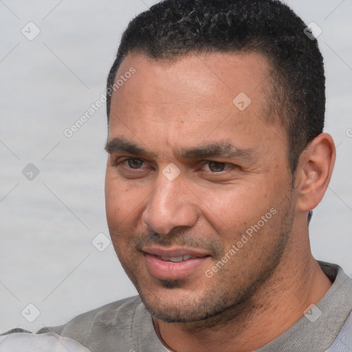 Joyful white adult male with short  black hair and brown eyes