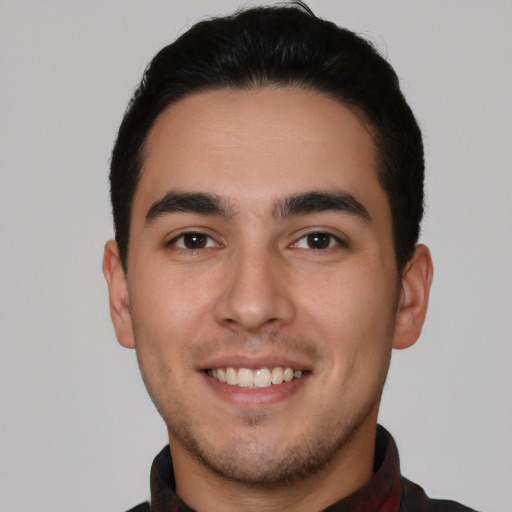 Joyful white young-adult male with short  black hair and brown eyes