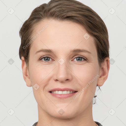 Joyful white young-adult female with short  brown hair and grey eyes